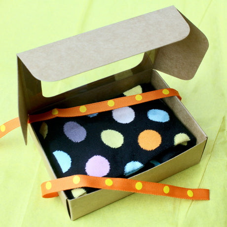 Mini treat box used without dividers for gift packaging for a pair of socks.