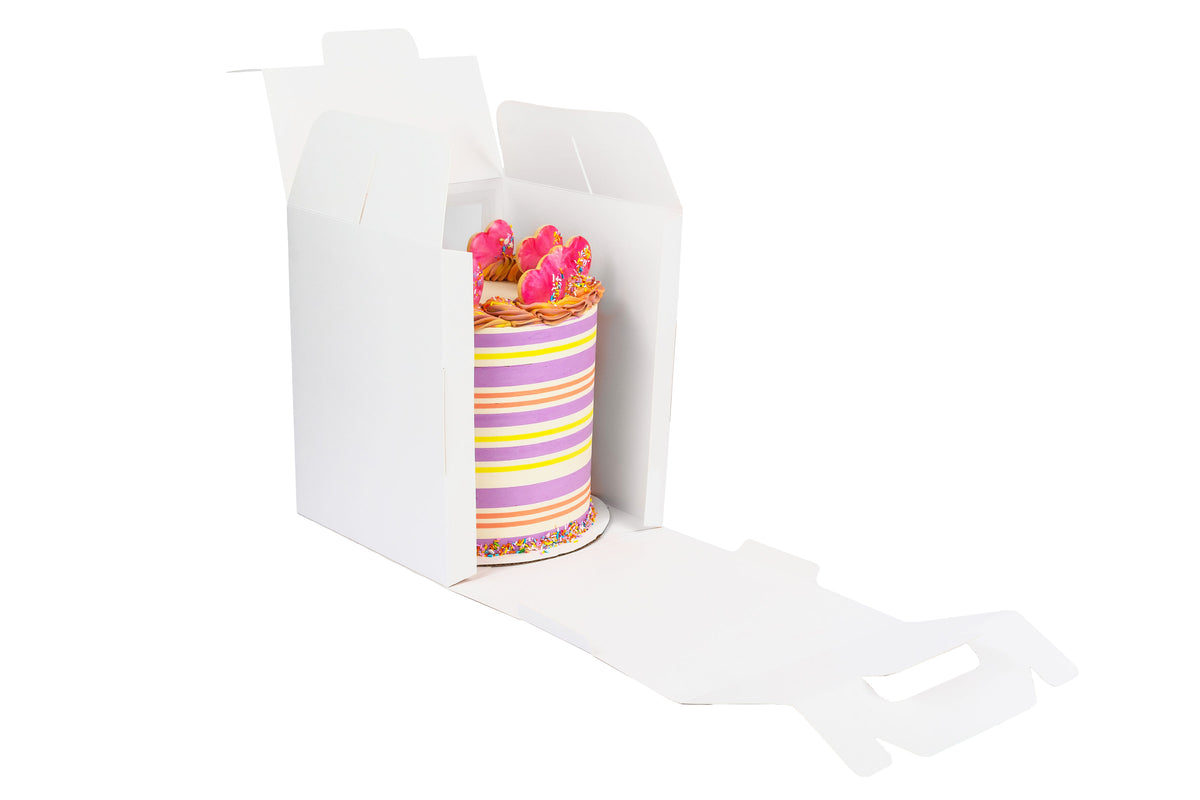A cake in an open 10x10x12 white paper cake box