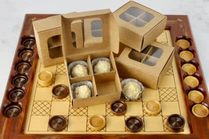 Mini treat box with dividers and window (four compartments) in kraft paper with white truffles on a checker board