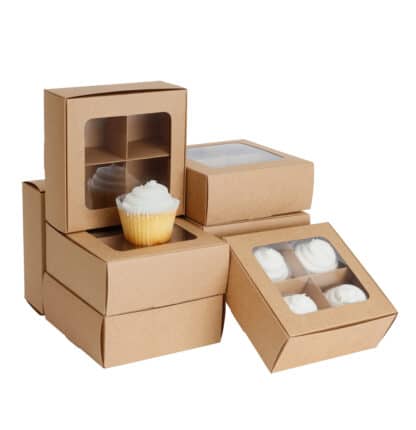 Stack of cookie boxes with dividers and window (four compartments) in kraft paper, with small cupcakes